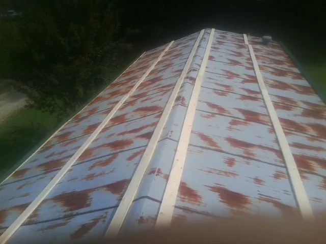 Rusted metal roof panels with new wood purlins before replacement — Storm Damage Roof Repair in Coopersburg by Roofing Brothers