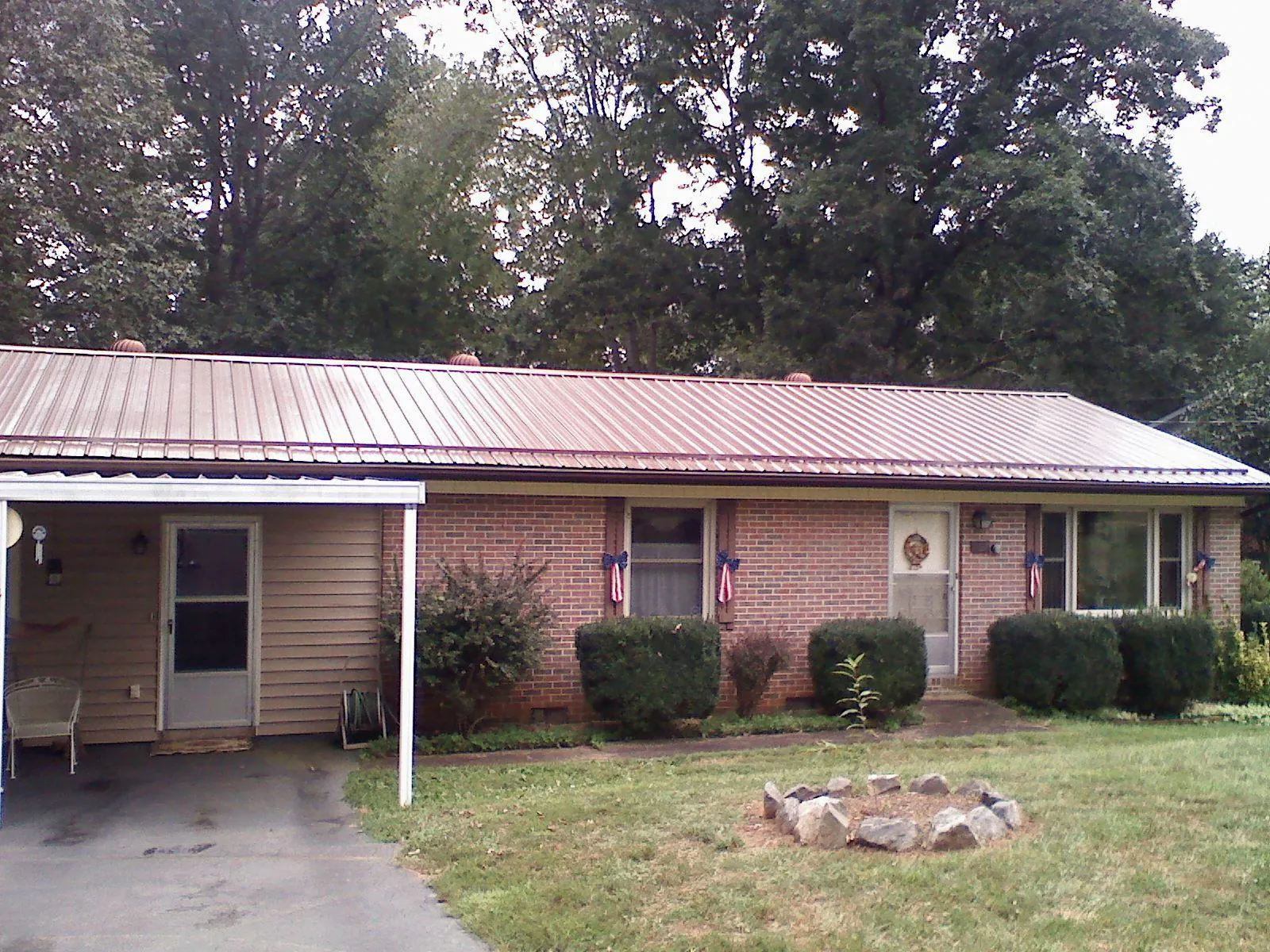 Bronze metal roof and carport on a brick ranch home — Roof Repair work by our crew in Coopersburg